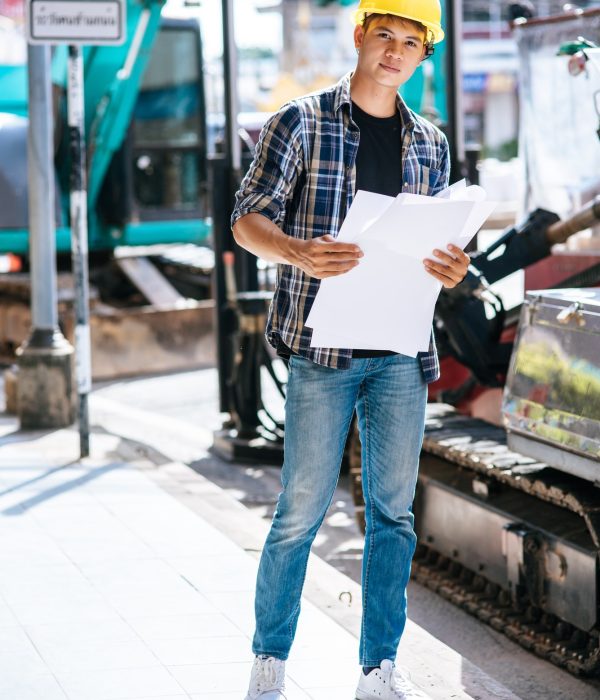 Civil engineers work on large road and machinery conditions.