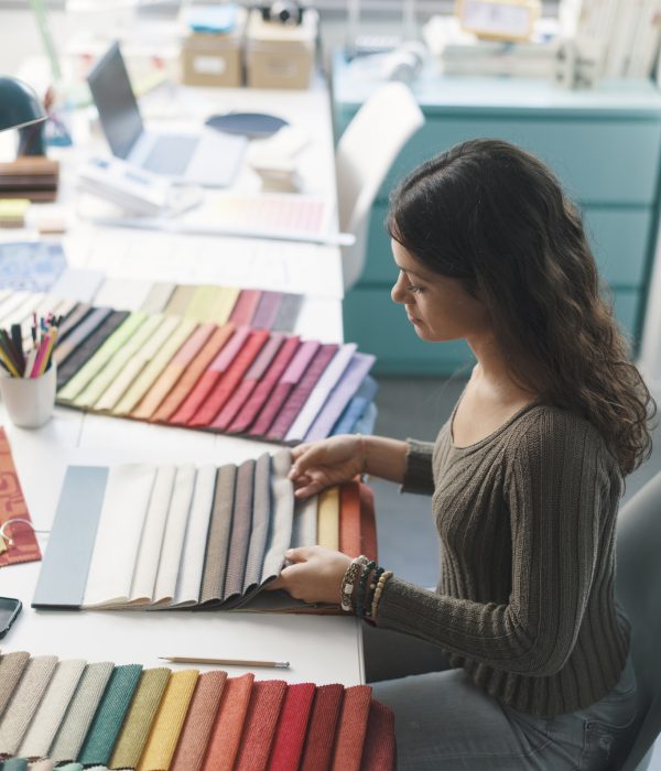 Young interior designer choosing fabric samples